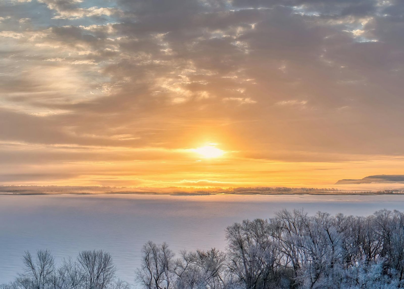 serene winter sunrise over frozen lake in minnesota