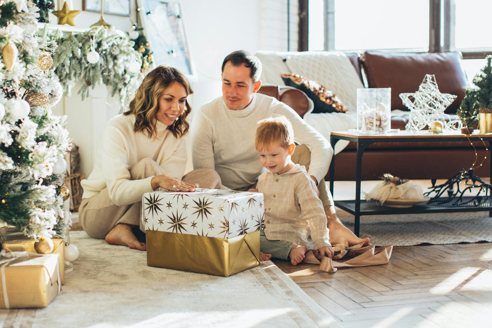 family sitting beside a gift